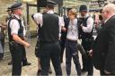 Police restrain a protester