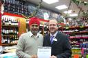 Prize attraction: Mr Singh receives the prize for world Wines from Keith Burrows