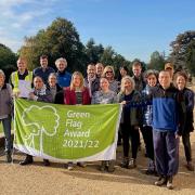 Roll out the banner: staff and volunteers with the Green Flag that can now be displayed