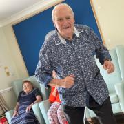 Cutting some shapes:  a resident gets into the swing of the party