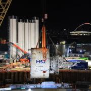 Landmark moment: Tunnel borer Anne is lowered into the ground, with the Wembley Arch in the background