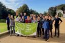 Roll out the banner: staff and volunteers with the Green Flag that can now be displayed