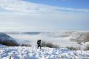 A person walks through snow (Danny Lawson/PA)