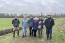 Planting team: volunteers get to work on last year's project, hedgerow planting