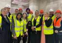 Hi-vizitors: Rupa Huq, fourth left, was among guests shown round the hub in The Oaks