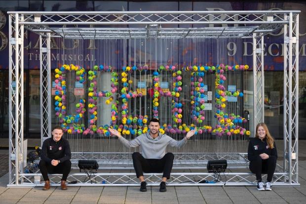Ealing Times: Members of Street Football Wales with National Lottery ball display
