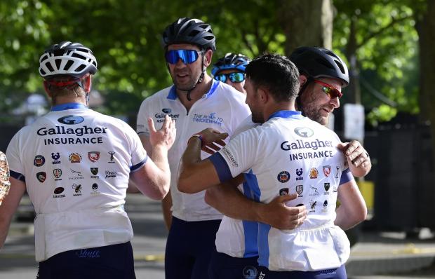 Ealing Times: Several former rugby professionals who took part in Gallagher's Road to Twickenham embrace at the finish