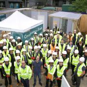 Hard hats all round: students on a tour of the Acton Gardens site