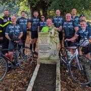 Ready for the off: cyclists beside the grave of Marta Cunningham